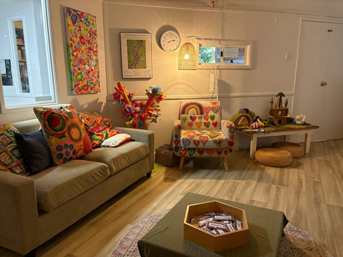 Toys and furniture arranged in a colorful children's play room.